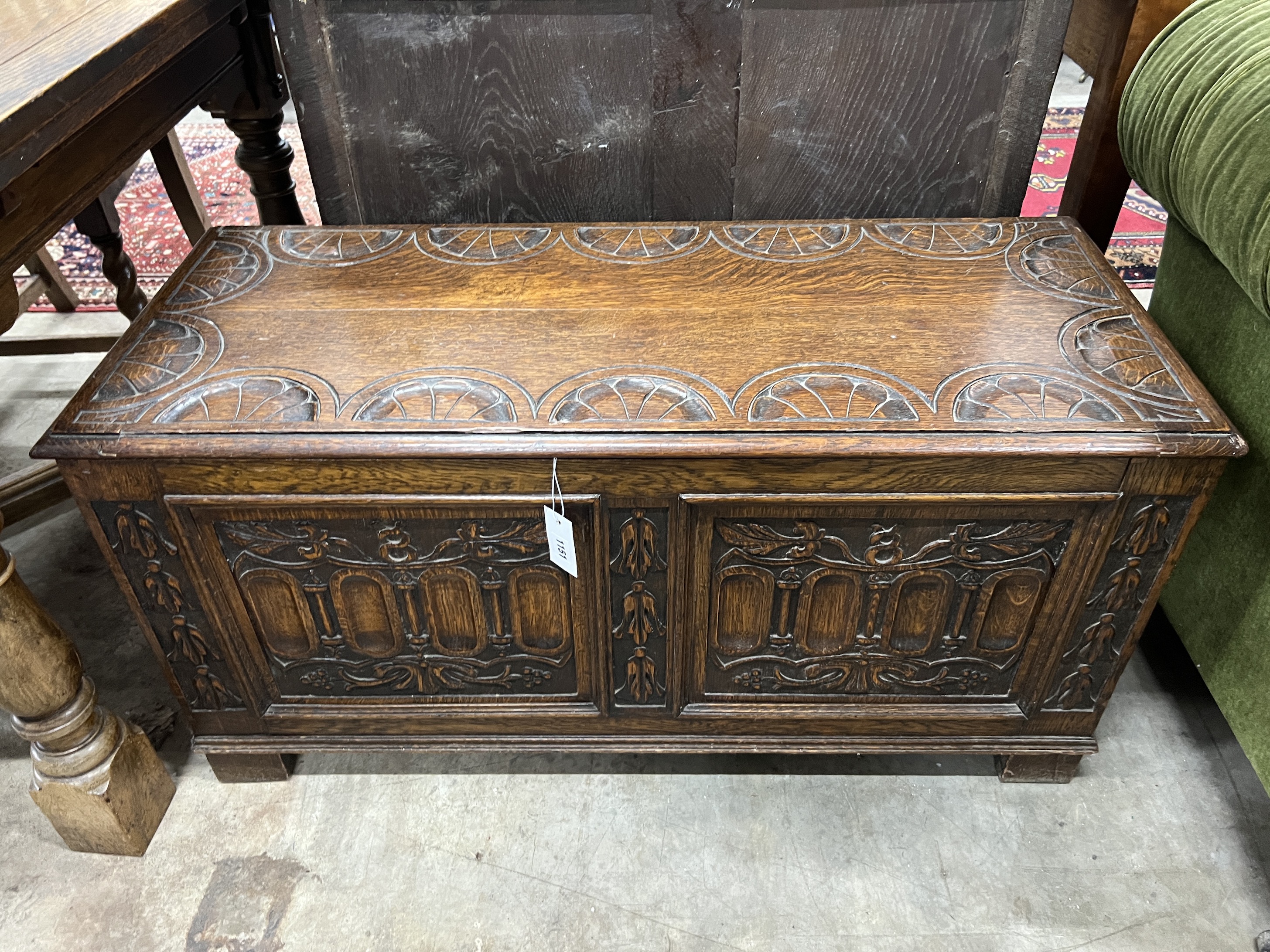 A 17th century style carved oak coffer, width 101cm, depth 42cm, height 51cm